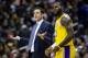 Los Angeles Lakers forward LeBron James (23) and head coach Luke Walton dispute a call during the first half of an NBA basketball game against the Washington Wizards, Sunday, Dec. 16, 2018, in Washington. (AP Photo/Al Drago)