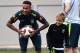 Brazil's forward Neymar (L) smiles past his son Davi Lucca during a training session at Yug Sport Stadium, in Sochi, on July 4, 2018, during the Russia 2018 World Cup football tournament. (Photo by NELSON ALMEIDA / AFP) (Photo credit should read NELSON ALMEIDA/AFP/Getty Images)