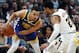 Golden State Warriors guard Stephen Curry, left, looks to pass the ball as Denver Nuggets guard Jamal Murray defends in the first half of an NBA basketball game, Tuesday, Jan. 15, 2019, in Denver. (AP Photo/David Zalubowski)