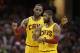 Cleveland Cavaliers' LeBron James, back, talks with Kyrie Irving in the first half of an NBA basketball game against the Orlando Magic, Saturday, Jan. 2, 2016, in Cleveland. (AP Photo/Tony Dejak)