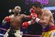 Floyd Mayweather Jr., left, lands a left against Manny Pacquiao, from the Philippines, during their welterweight title fight on Saturday, May 2, 2015 in Las Vegas. (AP Photo/John Locher)