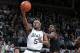 Michigan State's Cassius Winston, left, goes up for a layup against Maryland's Darryl Morsell during the first half of an NCAA college basketball game, Monday, Jan. 21, 2019, in East Lansing, Mich. (AP Photo/Al Goldis)