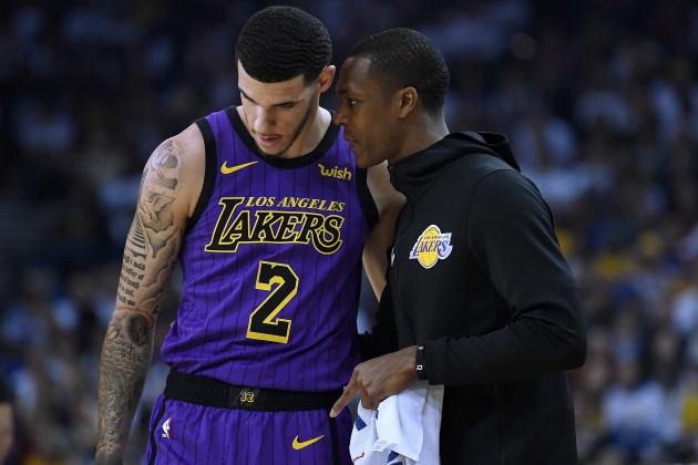 OAKLAND, CA - DECEMBER 25:  Lonzo Ball #2 of the Los Angeles Lakers listens to teammate Rajon Rondo #9 against the Golden State Warriors during the first half of their NBA Basketball game at ORACLE Arena on December 25, 2018 in Oakland, California. NOTE TO USER: User expressly acknowledges and agrees that, by downloading and or using this photograph, User is consenting to the terms and conditions of the Getty Images License Agreement.  (Photo by Thearon W. Henderson/Getty Images)