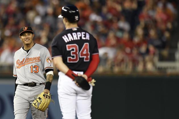 WASHINGTON, DC - JUNE 19: Bryce Harper #34 of the Washington Nationals talks with Manny Machado #13 of the Baltimore Orioles after hitting a RBI double in the fifth inning at Nationals Park on June 19, 2018 in Washington, DC. (Photo by Patrick McDermott/Getty Images)