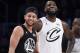 Team Stephen's Stephen Curry, left, of the Golden State Warriors, and Team LeBron's LeBron James, of the Cleveland Cavaliers, stand together during the first half of an NBA All-Star basketball game, Sunday, Feb. 18, 2018, in Los Angeles. (AP Photo/Chris Pizzello)