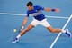 Serbia's Novak Djokovic hits a return against France's Lucas Pouille during their men's singles semi-final match on day 12 of the Australian Open tennis tournament in Melbourne on January 25, 2019. (Photo by DAVID GRAY / AFP) / -- IMAGE RESTRICTED TO EDITORIAL USE - STRICTLY NO COMMERCIAL USE -- (Photo credit should read DAVID GRAY/AFP/Getty Images)