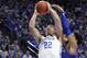 Kentucky's Reid Travis (22) shoots while pressured by Kansas' Dedric Lawson during the first half of an NCAA college basketball game in Lexington, Ky., Saturday, Jan. 26, 2019. (AP Photo/James Crisp)