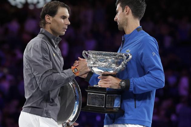 Serbia's Novak Djokovic, right, shakes hands with Spain's Rafael Nadal as they hold their trophies after Djokovic won the men's singles final at the Australian Open tennis championships in Melbourne, Australia, Sunday, Jan. 27, 2019. (AP Photo/Aaron Favila)