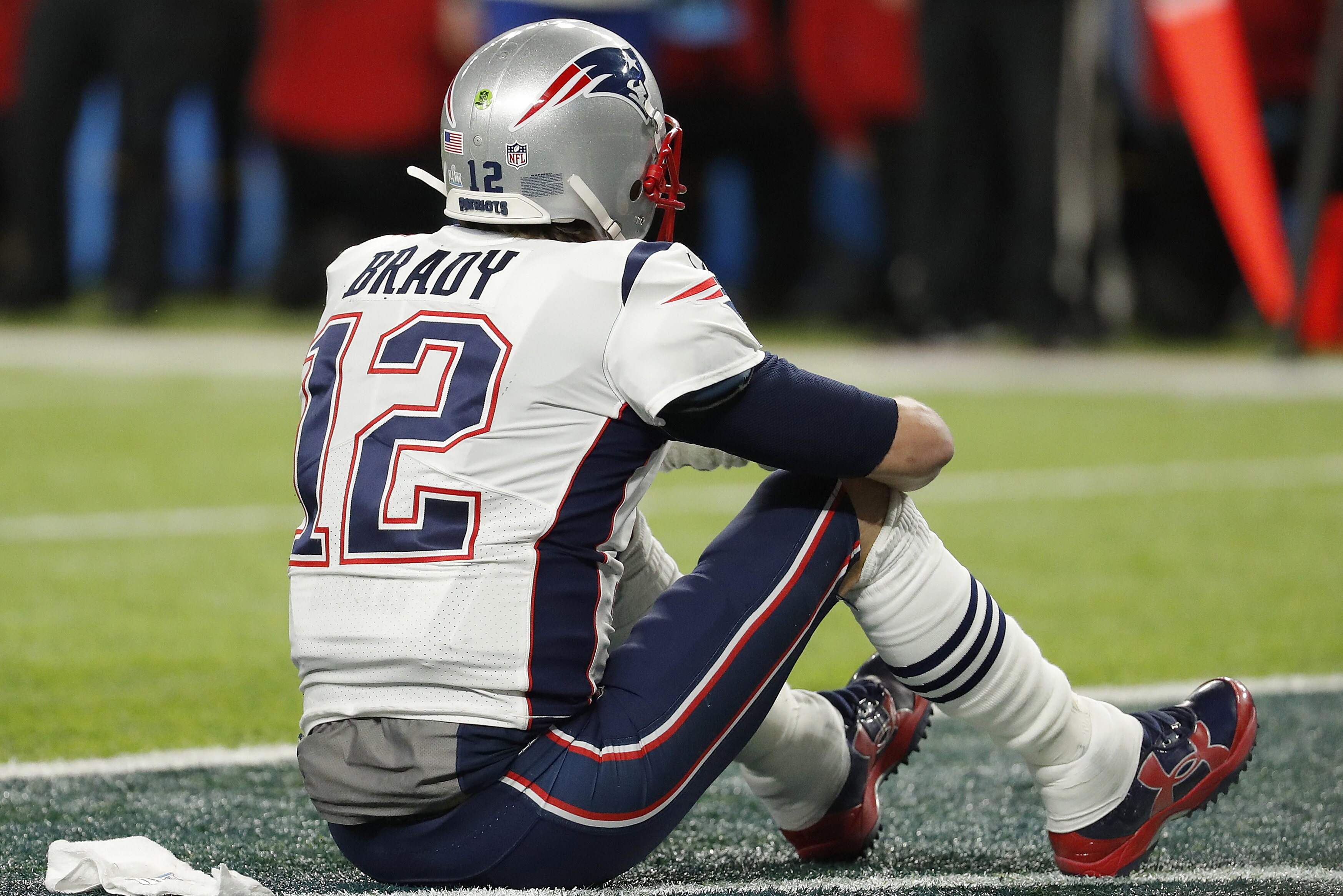 Tom Brady, de los Patriots de Nueva Inglaterra, se sienta en sobre el campo después de terminar el Super Bowl 52 contra los Eagles de Filadelfia el domingo 4 de febrero en Minneapolis. (AP Foto/Charlie Neibergall)