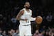 Boston Celtics' Kyrie Irving brings the ball up court during the second quarter of an NBA basketball game against the Miami Heat Monday, Jan. 21, 2019, in Boston. (AP Photo/Winslow Townson)