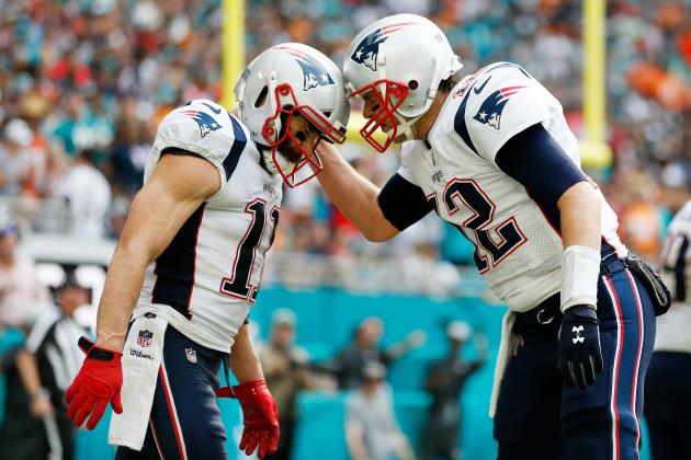 MIAMI, FL - DECEMBER 09:  Tom Brady #12 of the New England Patriots celebrates after setting the new record for touchdown passes in the regular season and playoffs combined with teammate Julian Edelman #11, who scored the touchdown, in the second quarter at Hard Rock Stadium on December 9, 2018 in Miami, Florida.  (Photo by Michael Reaves/Getty Images)