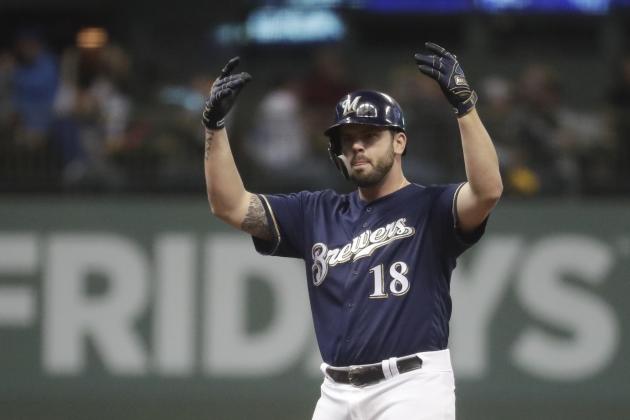 Milwaukee Brewers' Mike Moustakas reacts after hitting a double during the fourth inning of Game 2 of the National League Divisional Series baseball game against the Colorado Rockies Friday, Oct. 5, 2018, in Milwaukee. (AP Photo/Morry Gash)
