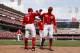 Cincinnati Reds' Joey Votto (19) celebrates with teammate Jose Peraza (9) and Eugenio Suarez (7) after hitting a two-run home run off Colorado Rockies starting pitcher Kyle Freeland in the sixth inning of a baseball game, Sunday, May 21, 2017, in Cincinnati. (AP Photo/John Minchillo)