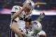 New England Patriots' David Andrews (60) picks up Tom Brady (12) after the Patriots scored a touchdown during the second half of the NFL Super Bowl 53 football game against the Los Angeles Rams Sunday, Feb. 3, 2019, in Atlanta. (AP Photo/Jeff Roberson)