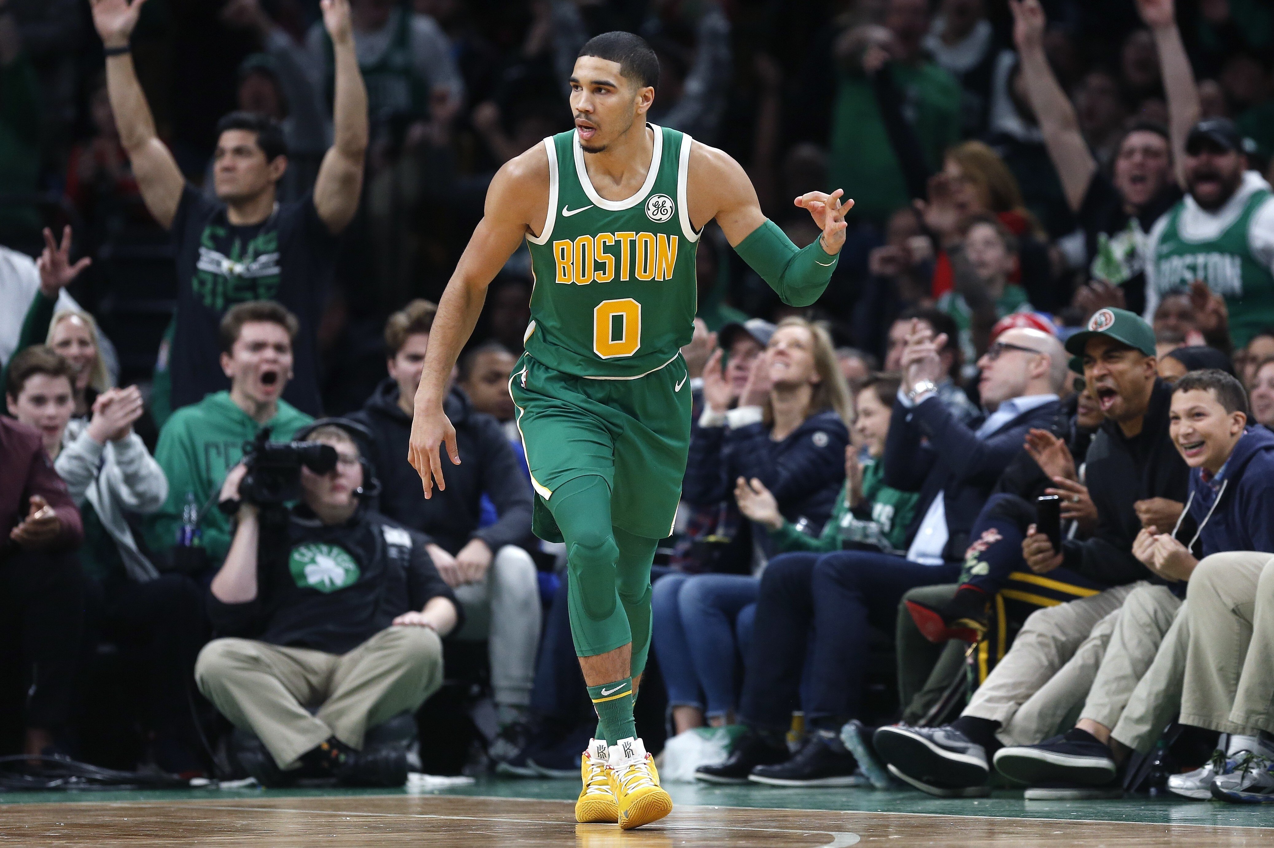 Boston Celtics' Jayson Tatum reacts after making a three-pointer during the second half of an NBA basketball game against the Philadelphia 76ers in Boston, Tuesday, Dec. 25, 2018. (AP Photo/Michael Dwyer)