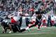 BIRMINGHAM, ALABAMA - FEBRUARY 10: Luis Perez #12 of Birmingham Iron avoids a tackle by Julius Warmsley #92 of Memphis Express during an Alliance of American Football game at Legion Field on February 10, 2019 in Birmingham, Alabama. (Photo by Joe Robbins/AAF/Getty Images)