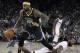 Golden State Warriors' DeMarcus Cousins (0) drives past Miami Heat forward James Johnson during the second half of an NBA basketball game, Sunday, Feb. 10, 2019, in Oakland, Calif. (AP Photo/Ben Margot)