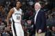 San Antonio Spurs guard DeMar DeRozan, left, confers with coach Gregg Popovich during a timeout in the second half of the team's NBA basketball game against the Denver Nuggets on Friday, Dec. 28, 2018, in Denver. The Nuggets won 102-99. (AP Photo/David Zalubowski)