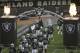 Oakland Raiders linebacker Xavier Woodson-Luster (56) touches the team logo as players run onto the field before an NFL preseason football game against the Seattle Seahawks in Oakland, Calif., Thursday, Aug. 31, 2017. (AP Photo/Jeff Chiu)