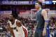 Miami Heat's Dwyane Wade (3) and Dallas Mavericks' Luka Doncic, watch free throws by the Heat in the first half of an NBA basketball game in Dallas, Wednesday, Feb. 13, 2019. (AP Photo/Tony Gutierrez)