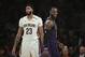 Los Angeles Lakers' LeBron James, right, smiles as he walks past New Orleans Pelicans' Anthony Davis during the first half of an NBA basketball game Friday, Dec. 21, 2018, in Los Angeles. (AP Photo/Jae C. Hong)