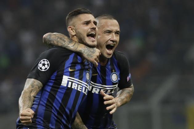 Inter Milan's Mauro Icardi , left, celebrates with his teammate Radja Nainggolan after scoring during the Champions League, group B soccer match between Inter Milan and Tottenham Hotspur, at the Milan San Siro Stadium, Italy, Tuesday, Sept. 18, 2018. (AP Photo/Luca Bruno)