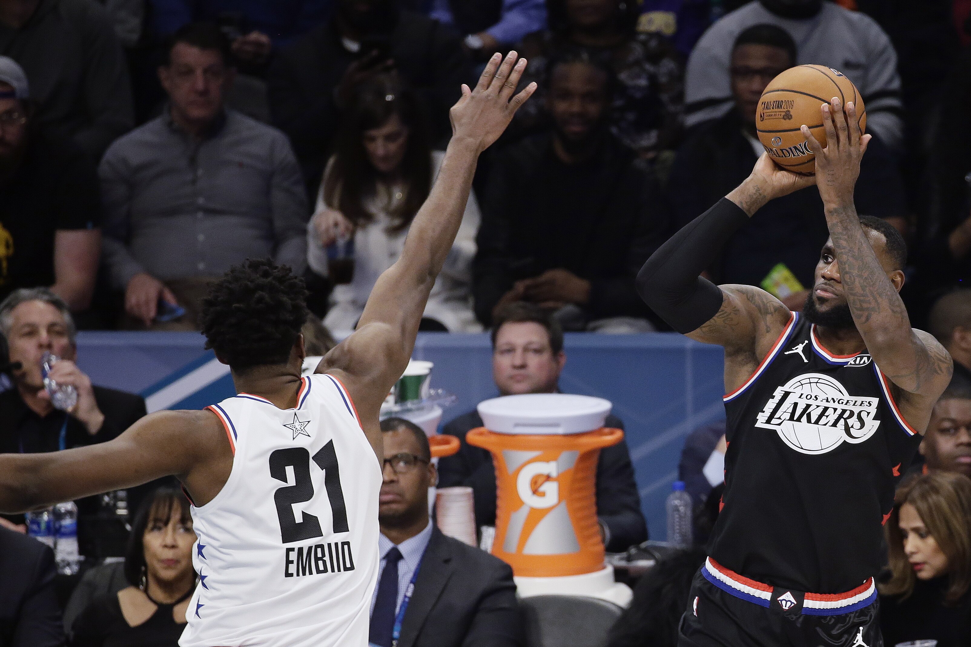 Team LeBron's LeBron James, of the Cleveland Cavaliers, shoots over Team Giannis' Joel Embiid, of the Philadelphia 76ers, during the second half of an NBA All-Star basketball game, Sunday, Feb. 17, 2019, in Charlotte, N.C. (AP Photo/Gerry Broome)