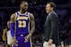 Los Angeles Lakers' head coach Luke Walton, right, talks things over with LeBron James, left, during the first half of an NBA basketball game against the Philadelphia 76ers, Sunday, Feb. 10, 2019, in Philadelphia. The 76ers won 143-120. (AP Photo/Chris Szagola)