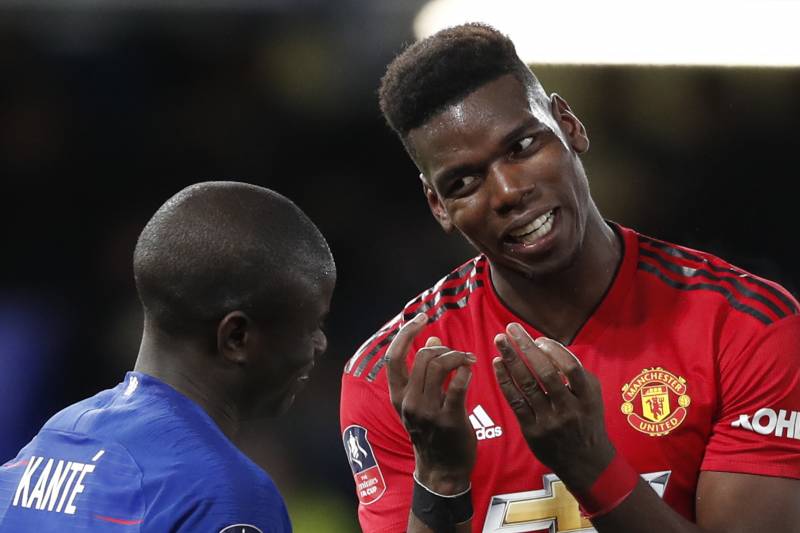 Manchester United's Paul Pogba, right, talks to Chelsea's N'Golo Kante after the English FA Cup fifth round soccer match between Chelsea and Manchester United at Stamford Bridge stadium in London, Monday, Feb. 18, 2019. (AP Photo/Alastair Grant)