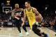 Golden State Warriors guard Stephen Curry, right, drives to the basket past Portland Trail Blazers guard Damian Lillard during the first half of an NBA basketball game in Portland, Ore., Wednesday, Feb. 13, 2019. (AP Photo/Steve Dykes)