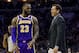 Los Angeles Lakers' head coach Luke Walton, right, talks things over with LeBron James, left, during the first half of an NBA basketball game against the Philadelphia 76ers, Sunday, Feb. 10, 2019, in Philadelphia. The 76ers won 143-120. (AP Photo/Chris Szagola)