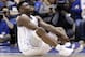 Duke's Zion Williamson sits on the floor following a injury during the first half of an NCAA college basketball game against North Carolina in Durham, N.C., Wednesday, Feb. 20, 2019. (AP Photo/Gerry Broome)