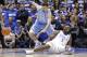 Duke's Zion Williamson (1) falls to the floor with an injury while chasing the ball with North Carolina's Luke Maye (32) during the first half of an NCAA college basketball game in Durham, N.C., Wednesday, Feb. 20, 2019. (AP Photo/Gerry Broome)
