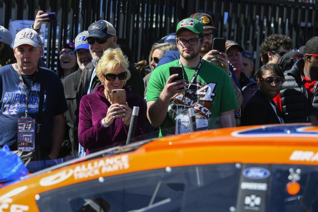 Fans watch as Brad Keselowski's car makes its way to inspection before a NASCAR Monster Energy NASCAR Cup Series auto race at Atlanta Motor Speedway, Sunday, Feb. 24, 2019, in Hampton, Ga. (AP Photo/John Amis)