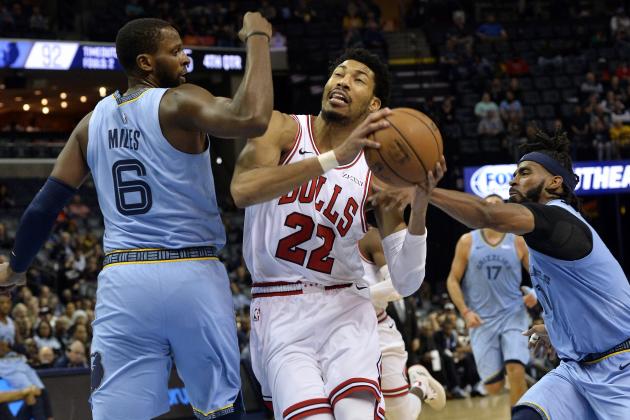 Chicago Bulls forward Otto Porter Jr. (22) drives between Memphis Grizzlies forward C.J. Miles (6) and guard Mike Conley in the second half of an NBA basketball game Wednesday, Feb. 27, 2019, in Memphis, Tenn. (AP Photo/Brandon Dill)
