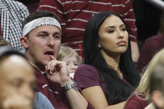 Former Texas A&M quarterback Johnny Manziel, left, and his wife, Bre Manziel, watch the second half of an NCAA men's college basketball tournament regional semifinal between Michigan and Texas A&M on Thursday, March 22, 2018, in Los Angeles. (AP Photo/Jae Hong)
