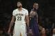 Los Angeles Lakers' LeBron James, right, smiles as he walks past New Orleans Pelicans' Anthony Davis during the first half of an NBA basketball game Friday, Dec. 21, 2018, in Los Angeles. (AP Photo/Jae C. Hong)