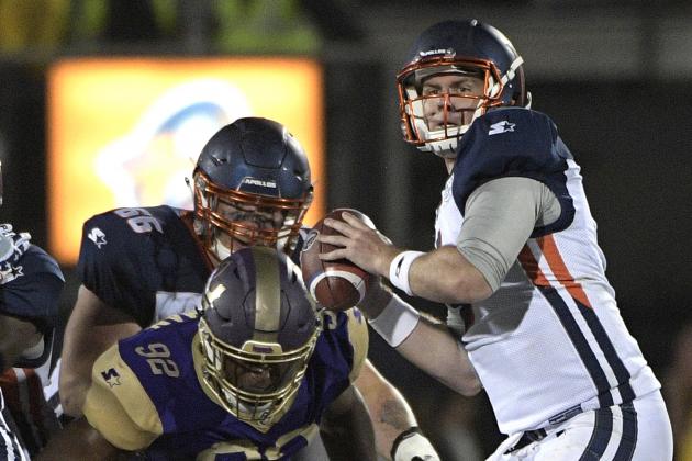 Orlando Apollos quarterback Garrett Gilbert, right, sets up to throw a pass in front of Atlanta Legends linebacker KeShun Freeman (92) during the first half of an Alliance of American Football game Saturday, Feb. 9, 2019, in Orlando, Fla. (AP Photo/Phelan M. Ebenhack)