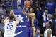 LSU's Tremont Waters (3) shoots between Kentucky's Reid Travis (22) and Ashton Hagans, right, during the second half of an NCAA college basketball game in Lexington, Ky., Tuesday, Feb. 12, 2019. LSU won 73-71. (AP Photo/James Crisp)