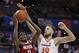 North Carolina State's DJ Funderburk (0) shoots against Virginia's Jay Huff (30) during the first half of an NCAA college basketball game in the Atlantic Coast Conference tournament in Charlotte, N.C., Thursday, March 14, 2019. (AP Photo/Nell Redmond)