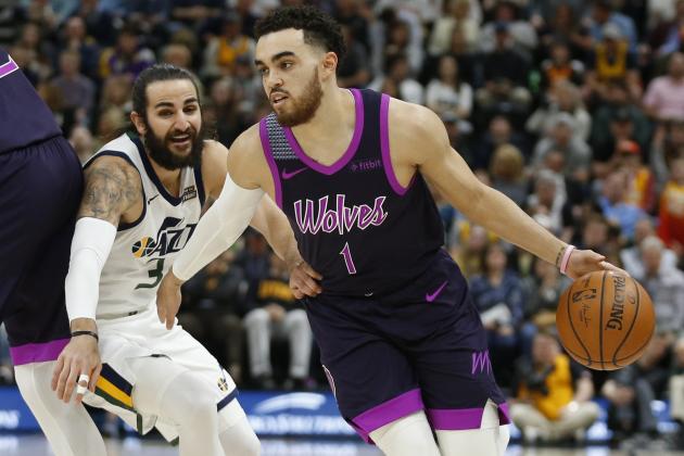 Minnesota Timberwolves guard Tyus Jones (1) drives around Utah Jazz guard Ricky Rubio (3) in the first half during an NBA basketball game Thursday, March 14, 2019, in Salt Lake City. (AP Photo/Rick Bowmer)