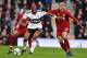 Fulham's Dutch defender Ryan Babel (L) vies with Liverpool's Brazilian midfielder Fabinho during the English Premier League football match between Fulham and Liverpool at Craven Cottage in London on March 17, 2019. (Photo by Glyn KIRK / AFP) / RESTRICTED TO EDITORIAL USE. No use with unauthorized audio, video, data, fixture lists, club/league logos or 'live' services. Online in-match use limited to 120 images. An additional 40 images may be used in extra time. No video emulation. Social media in-match use limited to 120 images. An additional 40 images may be used in extra time. No use in betting publications, games or single club/league/player publications. / (Photo credit should read GLYN KIRK/AFP/Getty Images)