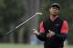 Tiger Woods flips his club after his shot to the 10th green during the final round of The Players Championship golf tournament Sunday, March 17, 2019, in Ponte Vedra Beach, Fla. (AP Photo/Lynne Sladky)