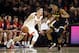 Virginia guard Kyle Guy, left, drives around Maryland guard Aaron Wiggins during the second half of an NCAA college basketball game Wednesday, Nov. 28, 2018, in College Park, Md. (AP Photo/Patrick Semansky)