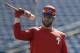 FILE - In this March 9, 2019 file photo Philadelphia Phillies' Bryce Harper waits his turn in the batting cage before a spring training baseball game against the Toronto Blue Jays in Clearwater, Fla. For the first time since 2011, the Washington Nationals will go through a season without any help from Bryce Harper. So it's rather likely this year will be viewed, at least in part, as a referendum on whether the Nationals should have figured out a way to keep the young slugger. (AP Photo/Chris O'Meara, file)