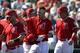 Los Angeles Angels' Mike Trout, center, is congratulated on his three-run home run against the Chicago Cubs in the third inning of a spring training baseball game Tuesday, March 5, 2019, in Tempe, Ariz. (AP Photo/Elaine Thompson)