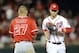 Washington Nationals left fielder Bryce Harper (34) runs from the field past Los Angeles Angels' Mike Trout (27) during the middle of the seventh inning of a baseball game, Monday, April 21, 2014, in Washington. The Angels won 4-2. (AP Photo/Nick Wass)