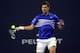 MIAMI GARDENS, FLORIDA - MARCH 22: Novak Djokovic of Serbia returns a shot to Bernard Tomic of Australia during the Miami Open Presented by Itau at Hard Rock Stadium March 22, 2019 in Miami Gardens, Florida. (Photo by Matthew Stockman/Getty Images)