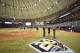 Tampa Bay Rays officials and grounds crew talk under emergency lightning after lightning strikes knocked out power inside Tropicana Field before the start of a game with the New York Yankees Monday, Sept. 24, 2018, in St. Petersburg, Fla. (AP Photo/Steve Nesius)