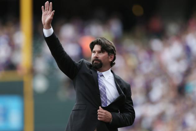 Retired Colorado Rockies first baseman Todd Helton waves at the crowd after his number was retired during a ceremony before the Rockies host the Cincinnati Reds in the first inning of a baseball game in Denver on Sunday, Aug. 17, 2014. (AP Photo/David Zalubowski)